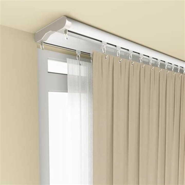 How do you hang curtain tracks?